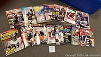 Photo showing 15 assorted sports magazines with covers featuring Tom Brady, Sidney Crosby, Brian Urlacher, Peyton Manning and others.