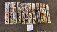 Photo of the 48 Brooke Bond tea cards arranged front side up showing botanical illustrations of various wild flowers.