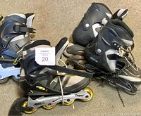 Two pairs of used inline rollerblades placed on carpet. Cooper brand pair in front has yellow wheels and visible wear. Second unknown pair behind with black wheels and lace closure.