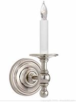 Close up of one polished nickel single-light wall sconce with candle-style socket and clear bulb installed.