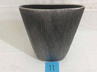 Front view of the decorative glass vase showing tapered shape and textured silver-black finish.