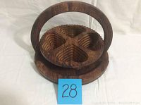 Front angled view of the folded wooden serving dish showing four heart-shaped compartments and handle.