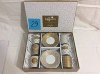 Overview of the boxed set showing all 6 cups and saucers neatly arranged in compartments with the lid open, showcasing the patterns.