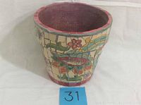 Front angled view of the ceramic planter showing detailed floral mosaic pattern and interior.