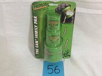 Set of three green cylindrical deer call cans in original retail packaging with visible price tags and some packaging damage.