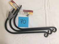 Three black forged steel plant hooks lined up, curved ends visible, some minor paint chips visible.