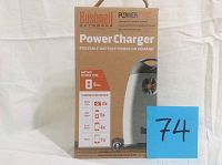 Box showing front of Bushnell Outdoors Power Charger PP2020 with features and charging capabilities listed