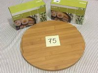 Two sealed Super Sushi Maker boxes displayed behind a round bamboo cutting board, showing complete lot contents.