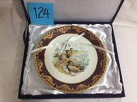 Plate inside original gift box with satin lining and white ribbon tied.