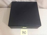 Top closed view of the black padded Argentum Acoustics lockable case showing minor scuff on one corner.