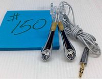 Pair of silver-tone Philips earbuds with Swarovski clear crystals embedded on each earpiece, fabric cable coiled beside them with gold-plated 3.5mm jack connected.