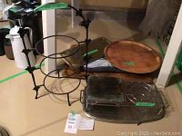Overview of assortment showing metal trays, wooden tray, and metal fondue warmer on one tray.