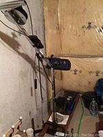 NordicTrack Ski Exerciser showing metal frame, cables, and control box mounted on a wooden base, placed against a basement wall.