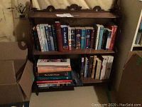 Front view of the wood shelf stand showing two shelves loaded with books (not included).