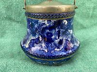 Side view showing detailed flow blue ceramic body with floral and abstract motifs