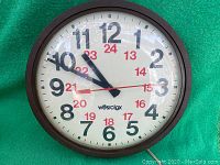 Front view of vintage Westclox wall clock showing full clock face with 12 and 24 hour markings and brown frame