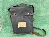 Black vinyl carrying bag with snap-button closure, attached lead security tag label reading 'ПН-3 № 191' intact