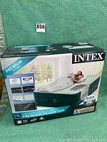 Boxed Intex inflatable air mattress, queen size 24in height with premium pillowtop surface shown on front display image.