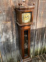 Full front view of tall case clock showing overall condition and design