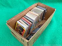 Cardboard box filled with multiple small stacks of rubber-banded trading cards