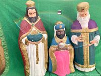 Full front view of all three Wise Men statues together, showing their size and details.