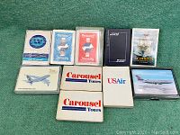 All 11 decks arranged on green surface showing front cases and branding