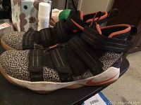 Side profile of Nike LeBron Zoom Soldier sneaker showing leopard print and multi-strap system