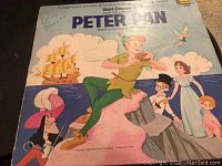 Front cover of the vintage Walt Disney Peter Pan LP showing Peter Pan, Wendy, John, Michael, Captain Hook, and Tinker Bell.