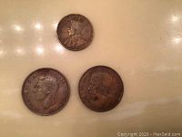 Three King George V large pennies, obverse side showing King George V portrait