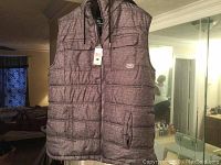 Men's sleeveless Ecko jacket vest in grey marled fabric with front zipper and side pockets, displayed hanging indoors.