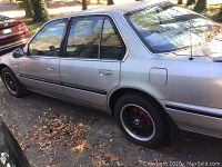 Driver side view showing overall exterior condition and aftermarket rims