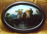 Front view of an antique oval convex bubble glass frame featuring a detailed reverse painted castle scene with towers, trees, and a bridge.