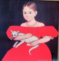 Close-up of the framed art print showing the girl in the red dress holding the white cat.