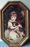 Photo of vintage painting of young girl holding dog in ornate octagonal Florentine style gold frame