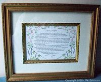 Framed letter from mother to daughter with floral border and gold ornate frame