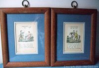 Two vintage framed grammar pictures side by side on a wall, displaying labeled articles and conjunctions illustrations.