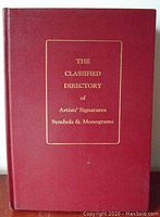 Front cover view showing the red hardcover with gold embossed title text.