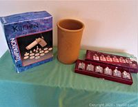 Photo showing all three items: box of Temptation cookie press with discs, terracotta wine decanter, and boxed Pfaltzgraff salt and pepper set.