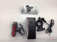 EBuyfire multifunctional bike light with user manual and three accessory components including a red rear light, a mounting bracket, and a USB cable
