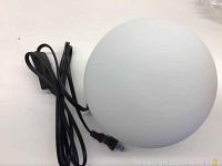 Frosted glass spherical lamp shade with attached power cord and switch shown from top angle