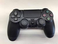 Black PS4 style wireless game controller with dual analog sticks, D-pad, action buttons, and touchpad.
