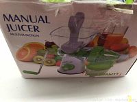 Box showing product image with manual juicer and wet basket cutter shown on packaging