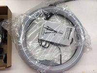 10.2 inch circular halo ring light in plastic wrapping with instruction booklet visible