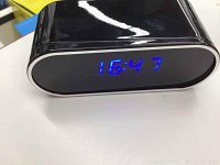 Black digital video camera showing time display of 16:47