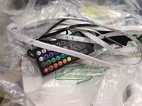 Photo of Minger and Govee RGB LED strip lights along with remote controls visible inside plastic packaging.