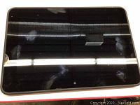 Front view of the turned-off Kindle Fire HD 8.9 inch tablet with visible fingerprints and smudges on the glass screen.