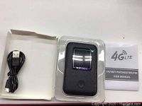 Wifi Box 4G LTE portable router in plastic packaging with micro USB cable and user manual visible in white box