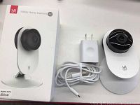 YI 1080p Home Camera, charging adapter and USB cable with original box