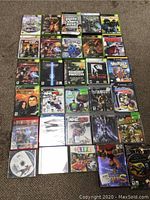 Photo shows a layout of 35 PS3 game cases and loose discs on a carpet with visible titles like Grand Theft Auto IV, Undertaker, NHL games, Infamous.