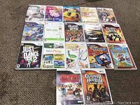 Photo showing 17 different Wii game cases arranged on carpet including multiple popular titles.